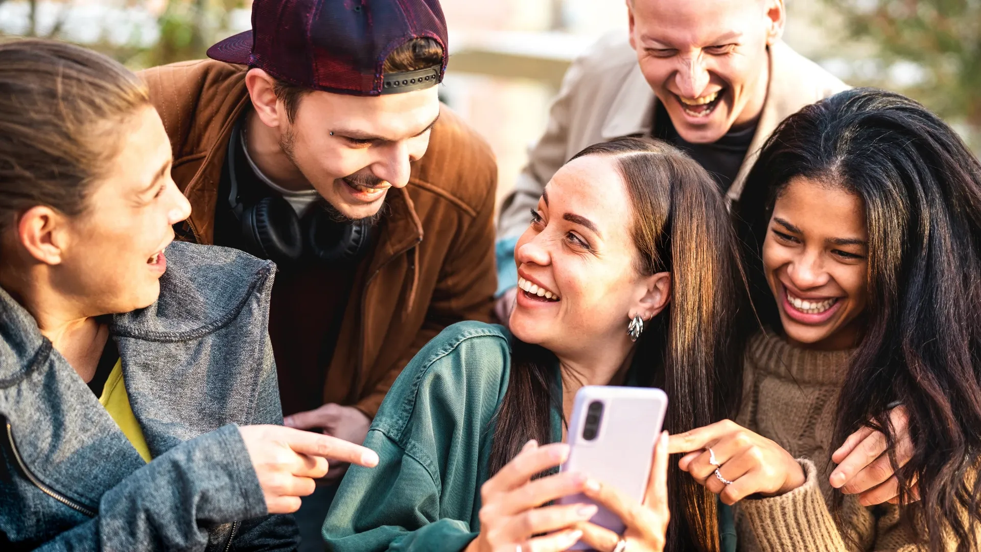 Group of friends eagerly explore a virtual tour of the venue they are attending a concert at